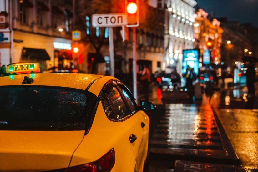 A Taxi in the Street at night with traffic