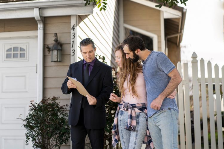 Couple signing papers for new house