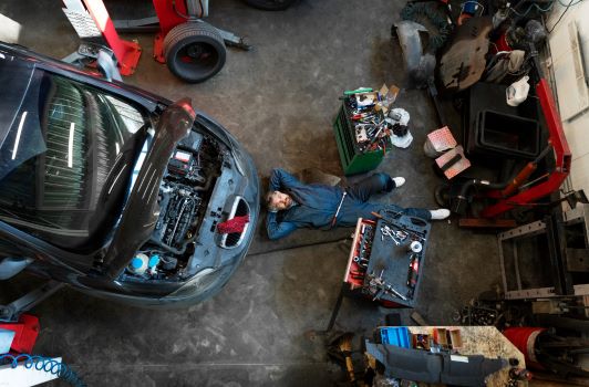 Top view man repairing car